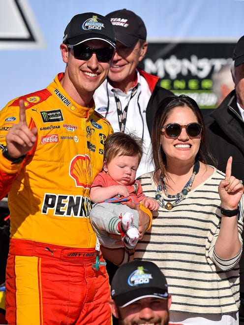 Joey Logano celebrates his victory at Talladega Superspeedway with his wife Brittany and his son Hudson on April 29, 2018.