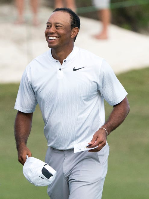Tiger Woods smiles on the 18th hole after the second round of the Hero World Challenge golf tournament