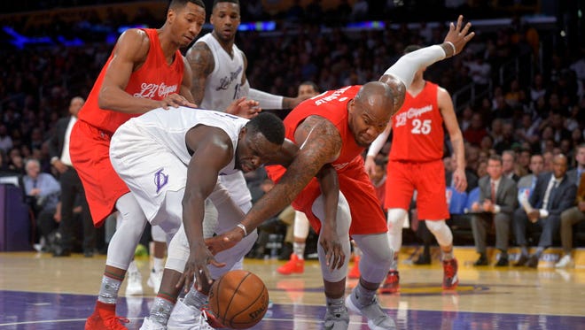 Clippers center Marreese Speights (5) goes for the ball with Lakers forward Luol Deng (9) during the second half.