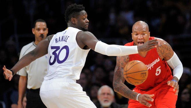 Clippers center Marreese Speights (5) turns the ball over against Lakers forward Julius Randle (30).