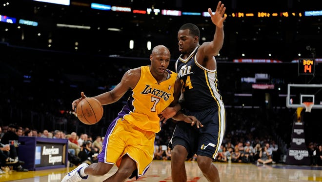 Los Angeles Lakers power forward Lamar Odom drives to the basket guarded by Utah Jazz power forward Paul Millsap at the Staples Center. (Oct 2010)
