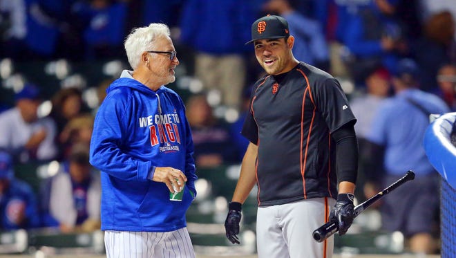 Game 1 in Chicago: Cubs manager Joe Maddon  talks with Giants starting pitcher Matt Moore.