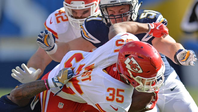 Chiefs running back Charcandrick West (35) is brought down by Chargers cornerback Casey Hayward (26) and outside linebacker Kyle Emanuel (51) during the first quarter.