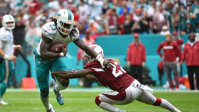 Arizona Cardinals strong safety Tony Jefferson (22) reaches for Miami Dolphins running back Jay Ajayi (23) during the first half at Hard Rock Stadium.