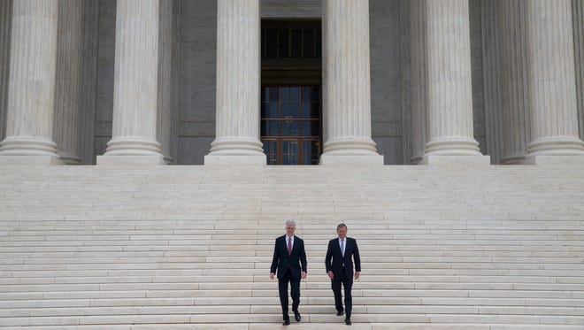 Newly installed Justice Neil Gorsuch, left, and Chief Justice John Roberts were key players in the Supreme Court's just completed term.