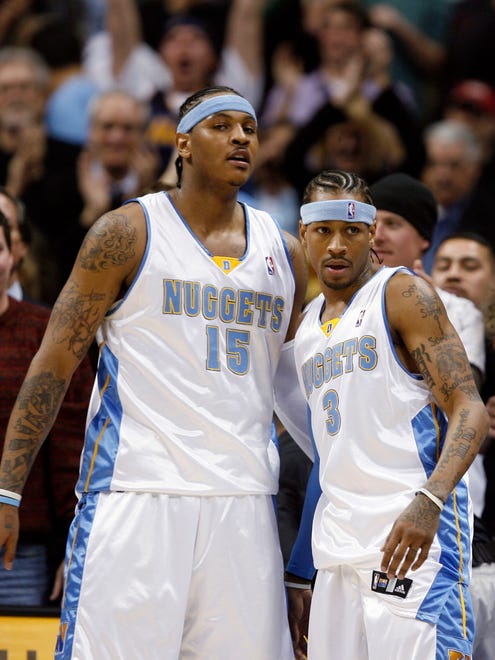 After playing with each other for the first time in Nuggets uniforms, Carmelo Anthony congratulates Allen Iverson as they come out of the game in the fourth quarter.