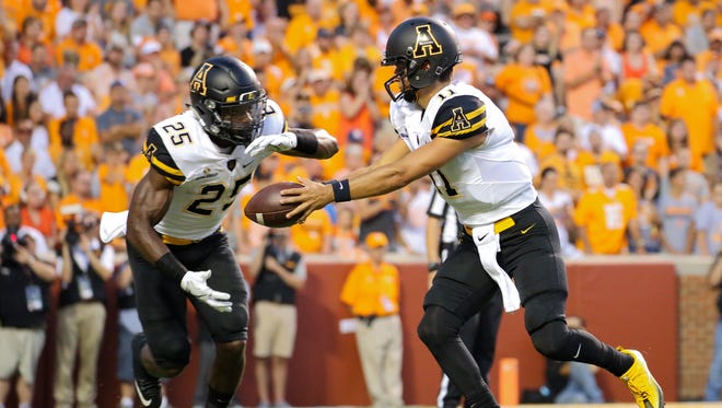 Appalachian State Mountaineers quarterback Taylor Lamb hands off to running back Jalin Moore.