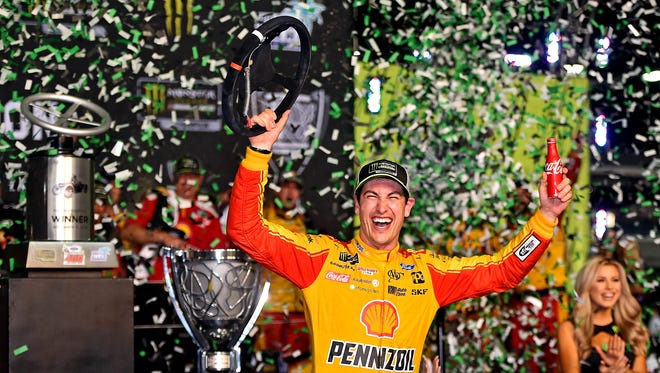 Joey Logano celebrates after winning the Ford EcoBoost 400 and the NASCAR Cup Series championship at Homestead-Miami Speedway.