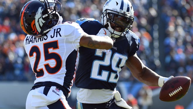 Tennessee Titans running back DeMarco Murray (29) carries the ball as Denver Broncos cornerback Chris Harris Jr. (25) defends during the first half at Nissan Stadium.
