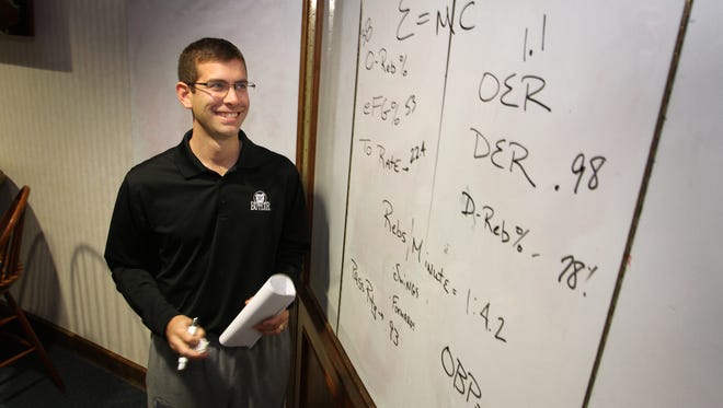 PHOTO ILLUSTRATION: Butler basketball coach Brad Stevens poses with a board of numbers and analytics, Tuesday, November 8, 2011 in a photo illustration.  Kelly Wilkinson / The Star