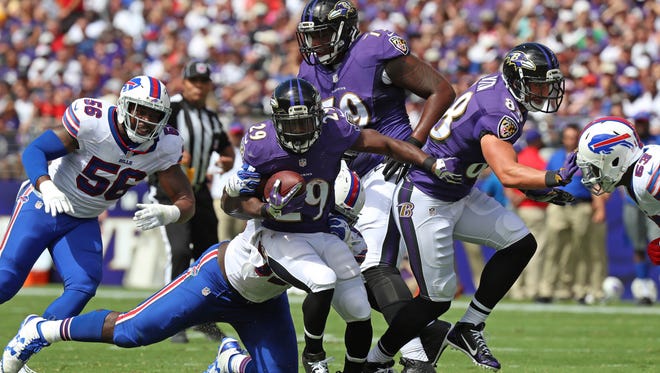 Baltimore Ravens running back Justin Forsett  (29) carries the ball against the Buffalo Bills during the first quarter at M&T Bank Stadium.