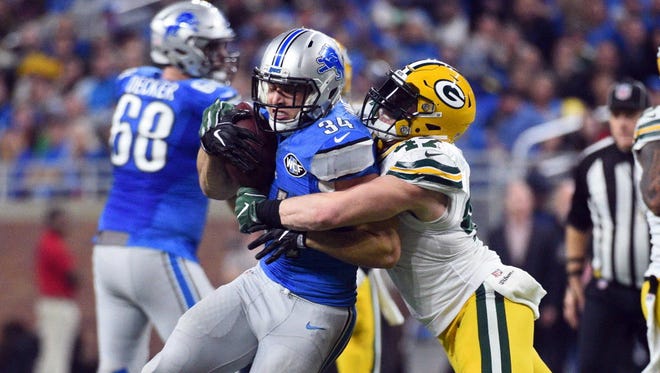 Lions fullback Zach Zenner (34) is tackled by Packers linebacker Jake Ryan (47) during the second quarter.