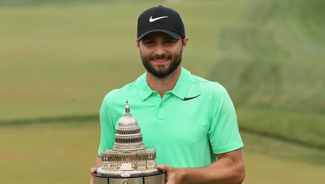 Kyle Stanley celebrates with the championship trophy after winning the Quicken Loans National at TPC Potomac on July 2.