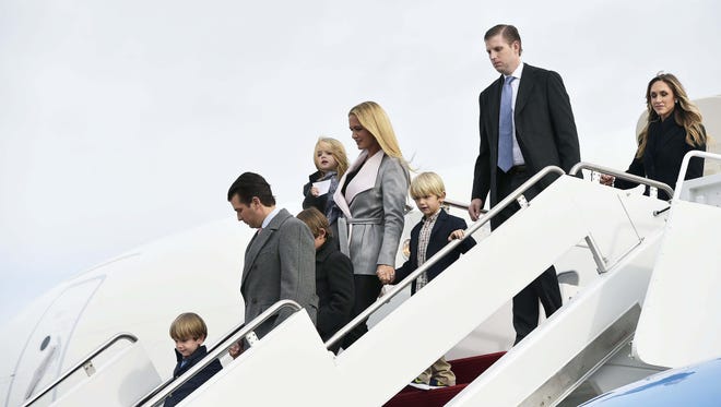 President-elect Donald Trump's sons Eric Trump (2nd R) Donald Trump Jr. (2nd L) and their families, step off a plane upon arrival at Andrews Air Force Base.