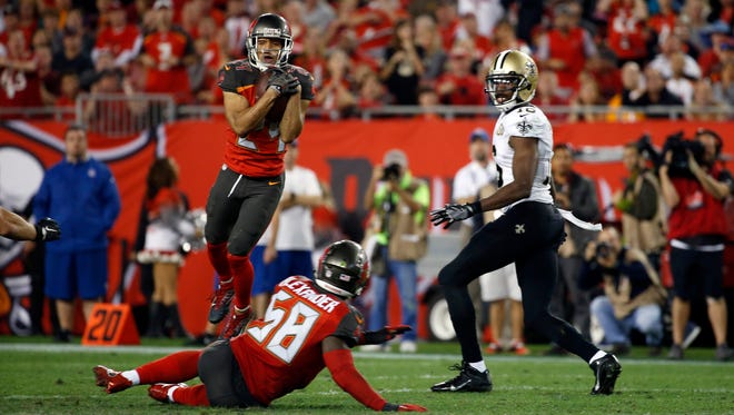 Buccaneers cornerback Brent Grimes (24) intercepts the ball against the Saints during the second half.