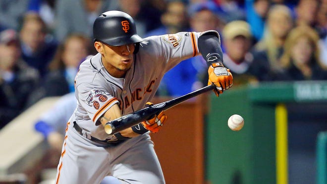 Game 1 in Chicago: Giants center fielder Gorkys Hernandez bunts for a single during the first inning.