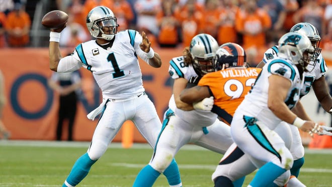 Carolina Panthers quarterback Cam Newton (1) drops back to pass in the first quarter against the Denver Broncos.