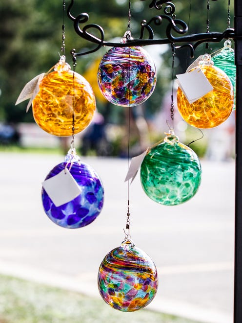 Hand-blown glass ornaments by artist Douglas Becker of Bethel, MN. glisten in the sun during the 47th annual Oconomowoc Festival of the Arts in Fowler Park on Saturday, August 19, 2017.