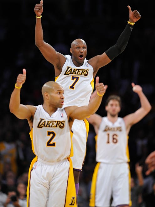 Lakers Derek Fisher, Lamar Odom and Pau Gasol signal for a tie ball during a play against the Denver Nuggets at Staples Center. (Apr 2011)