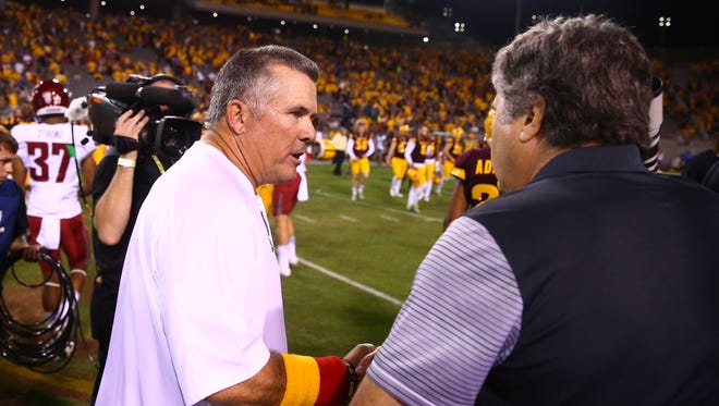 Arizona State Sun Devils head coach Todd Graham (left) has some words for Washington State Cougars head coach Mike Leach.
