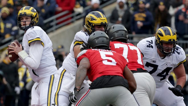 Michigan quarterback Wilton Speight looks downfield during the first half of their game against Ohio State on Saturday, Nov. 26, 2016.