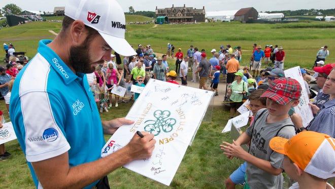 Troy Merritt signs autographs during practice rounds.