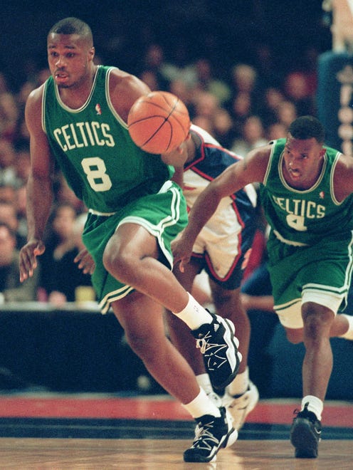 1997: Antoine Walker drives the ball down the court with teammate Chauncy Billups behind him during.
