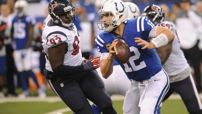 Indianapolis Colts quarterback Andrew Luck (12) runs out of the pocket during the first half against the Houston Texans at Lucas Oil Stadium.