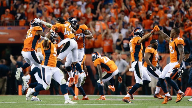 The Denver Broncos celebrate after Carolina kicker Graham Gano's potential game-winner sailed wide.