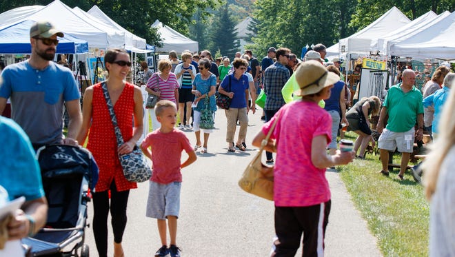Shoppers browse through a variety of handmade arts and crafts at the Donna Lexa Memorial Art Fair in Wales on Saturday, August 19, 2017. The annual event features arts and crafts, food, children's activities, live entertainment and more.