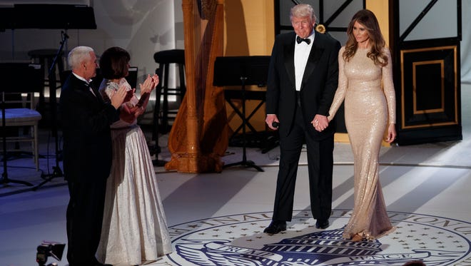 Vice President-elect Mike Pence, left, and his wife Karen, second from left, applaud as President-elect Donald Trump and his wife Melania arrive for a VIP reception and dinner at Union Station with donors in Washington D.C.