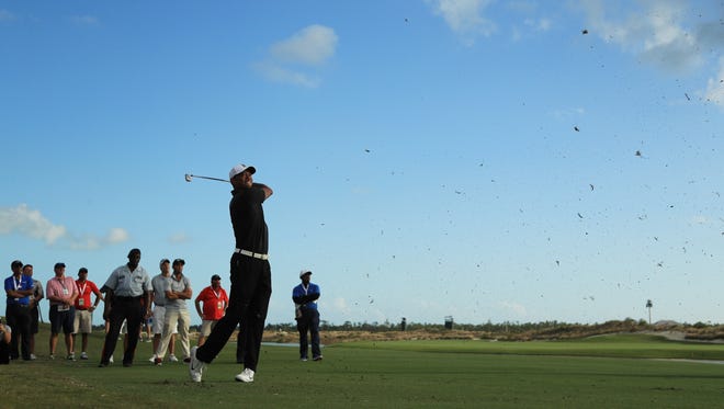 Tiger Woods plays a shot on the 18th hole during the first round of the Hero World Challenge on Thursday in Nassau, Bahamas.