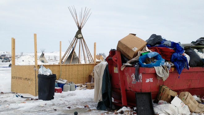 Trash is seen piled in a dumpster at an encampment set up near Cannon Ball, N.D., Wednesday, Feb. 8, 2017, for opponents against the construction of the Dakota Access pipeline.
