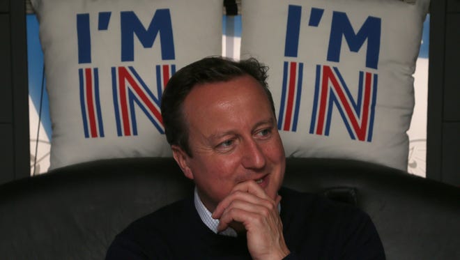 British Prime Minister David Cameron reacts as he travels on his campaign bus from Bristol,  England, on June 22, 2016, as the prime minister campaigns to avoid a Brexit ahead of the EU referendum. Rival sides threw their efforts into the final day of campaigning Wednesday, on the eve of Britain's vote on EU membership that will shape the future of Europe.