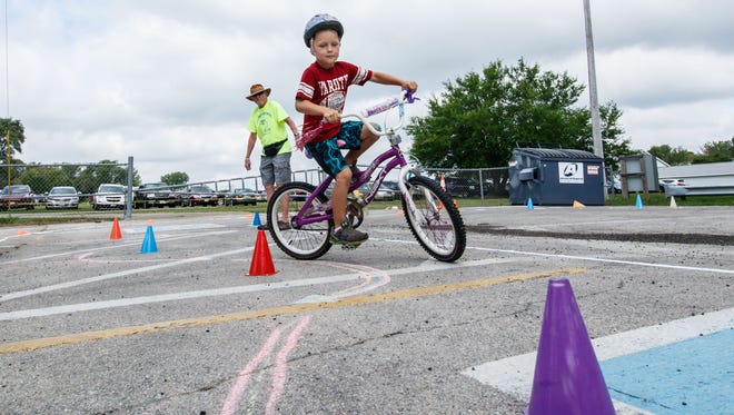 Cole Dieringer, 6, of Oconomowoc tests his cycling skill during Oconomowoc Kid's Fest at Roosevelt Park on Tuesday, August 15, 2017.