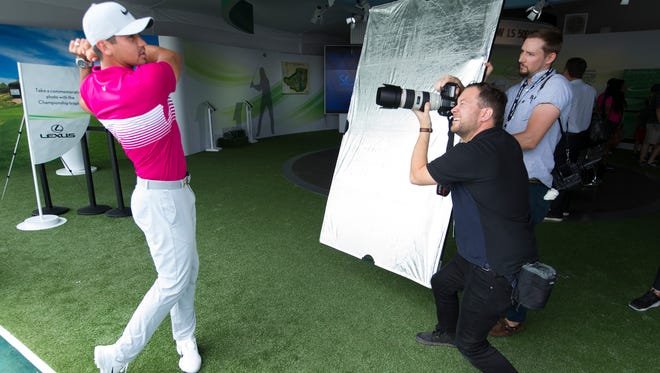 Jason Day (left) poses for photos during a Lexus promotional appearance during practice rounds.