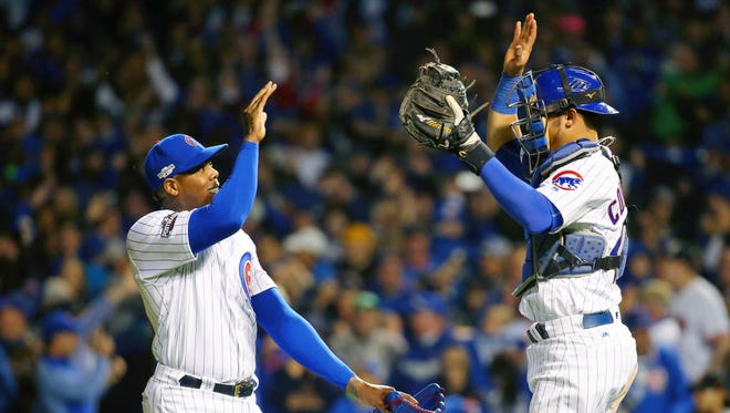 Game 2 at Chicago: Cubs relief pitcher Aroldis Chapman and catcher Willson Contreras celebrate their win.