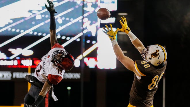 Wyoming tight end Jacob Hollister makes a catch for a touchdown against San Diego State safety Malik Smith at the Mountain West Championship Game at War Memorial Stadium in Laramie, Wyo.