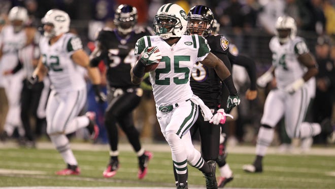 New York Jets kick returner Joe McKnight (25) runs a kickoff back for a first quarter touchdown against the Baltimore Ravens at M&T Bank Stadium in 2011.