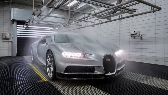 A Bugatti Chiron takes a bath inside the production building.