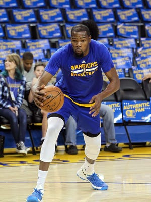 Golden State Warriors forward Kevin Durant (35) warm ups before the game against the Houston Rockets at Oracle Arena.