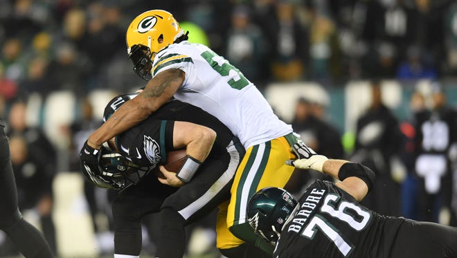 Eagles quarterback Carson Wentz (11) is sacked by Packers linebacker Julius Peppers (56).