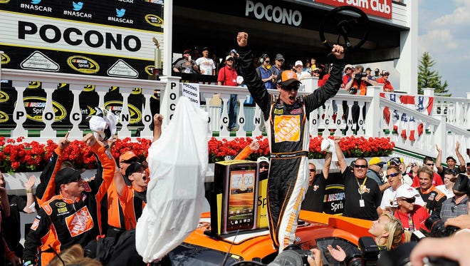 Driver Joey Logano celebrates after winning his second Sprint Cup series at the Pocono 400 at Pocono Raceway. He became the first driver in 30 races to win from the pole position.