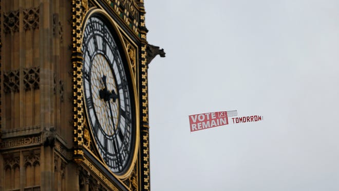 A pro-EU banner being towed behind a plane passes Big Ben in the Houses of Parliament  in London on June 22, 2016, on the final day of the EU referendum campaign before Britain goes to the polls to vote on continuing its membership in the EU.