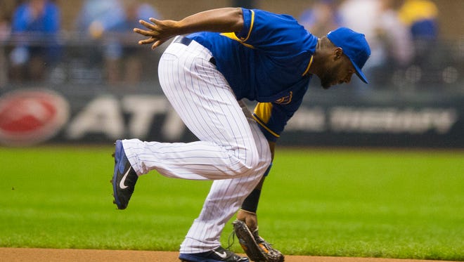 Brewers first baseman Chris Carter catches a line drive for the first out of a triple play.