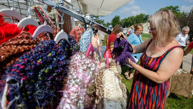 Claudia Abt from the Town of Genesee shops for handcrafted items at the Donna Lexa Memorial Art Fair in Wales on Saturday, August 19, 2017. The annual event features arts and crafts, food, children's activities, live entertainment and more.