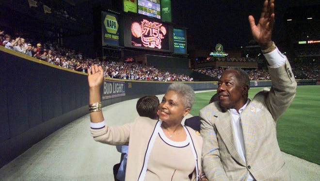 Hank Aaron and his wife Billye take a lap in a golf cart around Turner Field in 1999, after a ceremony to mark the 25th anniversary of his breaking Babe Ruth's record.