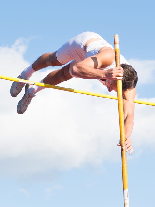 Jared Jones of Kettle Moraine clears the bar at 14 feet in the boys pole vault. Mukwonago's Bailey Kroll also went 14 feet, but Jones was credited with the victory.