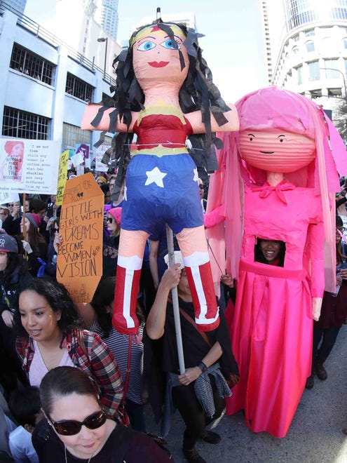 A Princess Bubble Gum and a Wonder Woman effigy are carried as tens of  thousands of demonstrators participate in the Woman's March in Los Angeles, Saturday to protest Donald J. Trump who took the oath of office and was sworn in as the 45th President of the United States. Protest rallies were held in over 30 countries around the world in solidarity with the Women's March on Washington in defense of press freedom, women's and human rights.