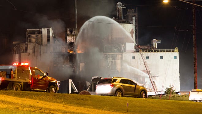 This Thursday, June 1, 2017, photo provided by Jeff Lange shows firefighters at the scene following an explosion and fire at the Didion Milling plant in Cambria, Wis. Recovery crews searched a mountain of debris on Thursday following a fatal explosion late Wednesday at the corn mill plant, which injured about a dozen people and leveled parts of the sprawling facility in southern Wisconsin, authorities said.
